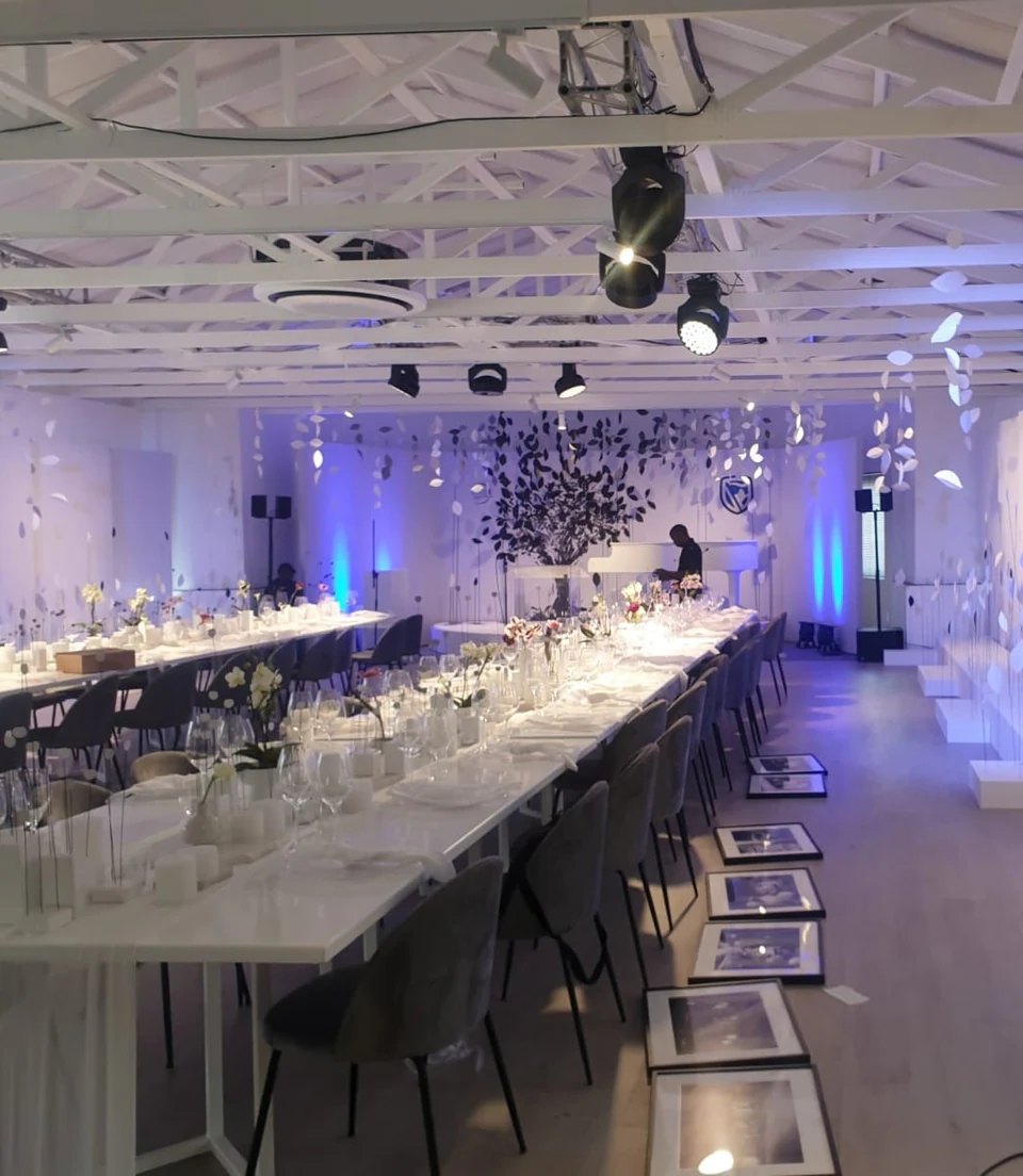 A long banquet table dressed for an evening event