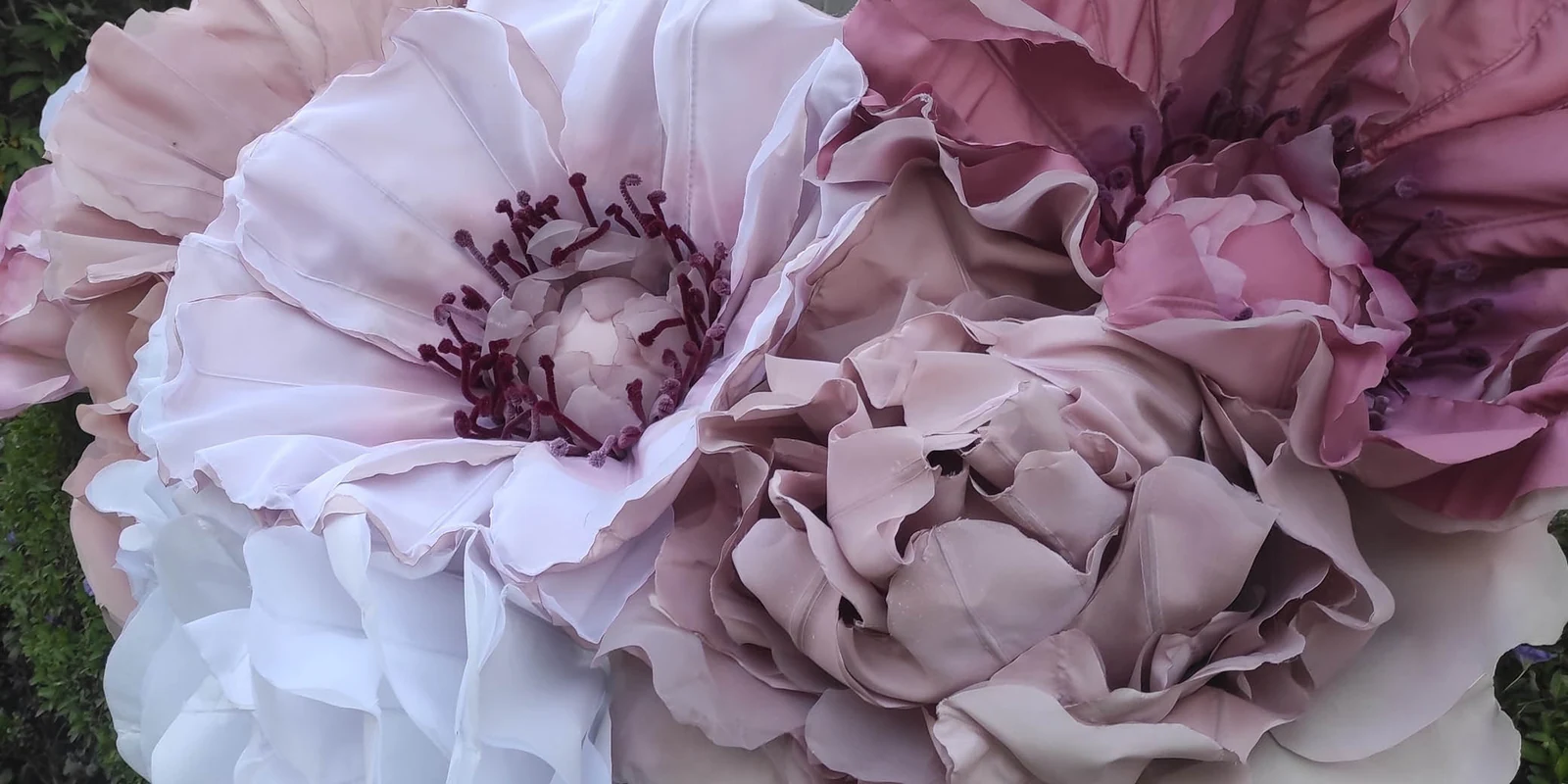 A close view of large fabric flowers in pink, purple and white