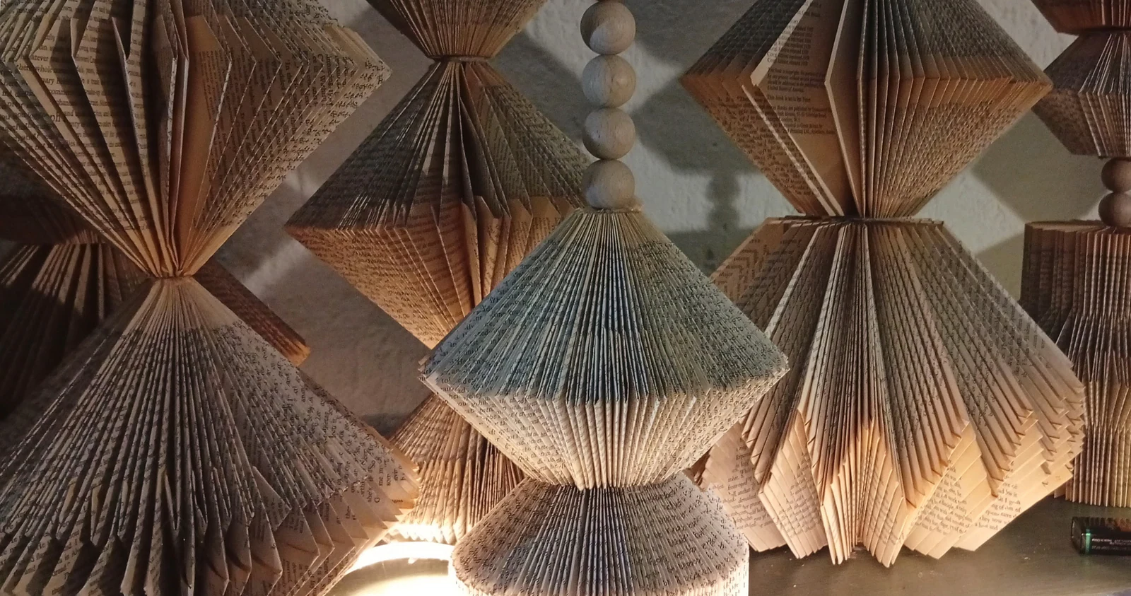 Close view of book pages folded into repeating fans