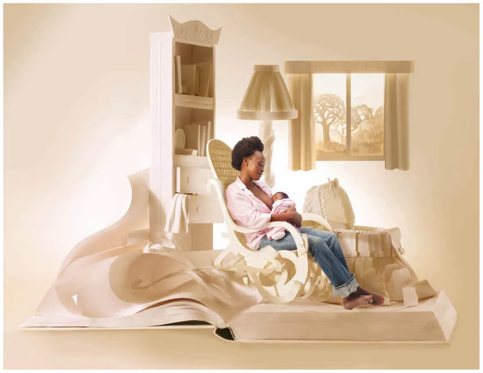 A paper nursery rising out of an open book, a mother rocking her baby