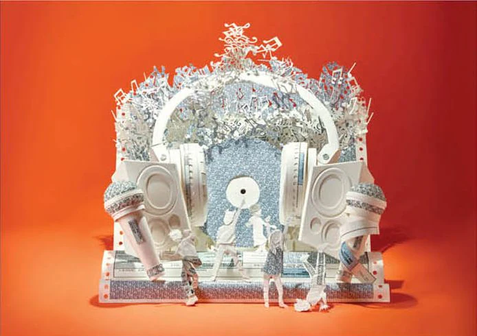 White paper music scene with headphones and speakers on an orange backdrop